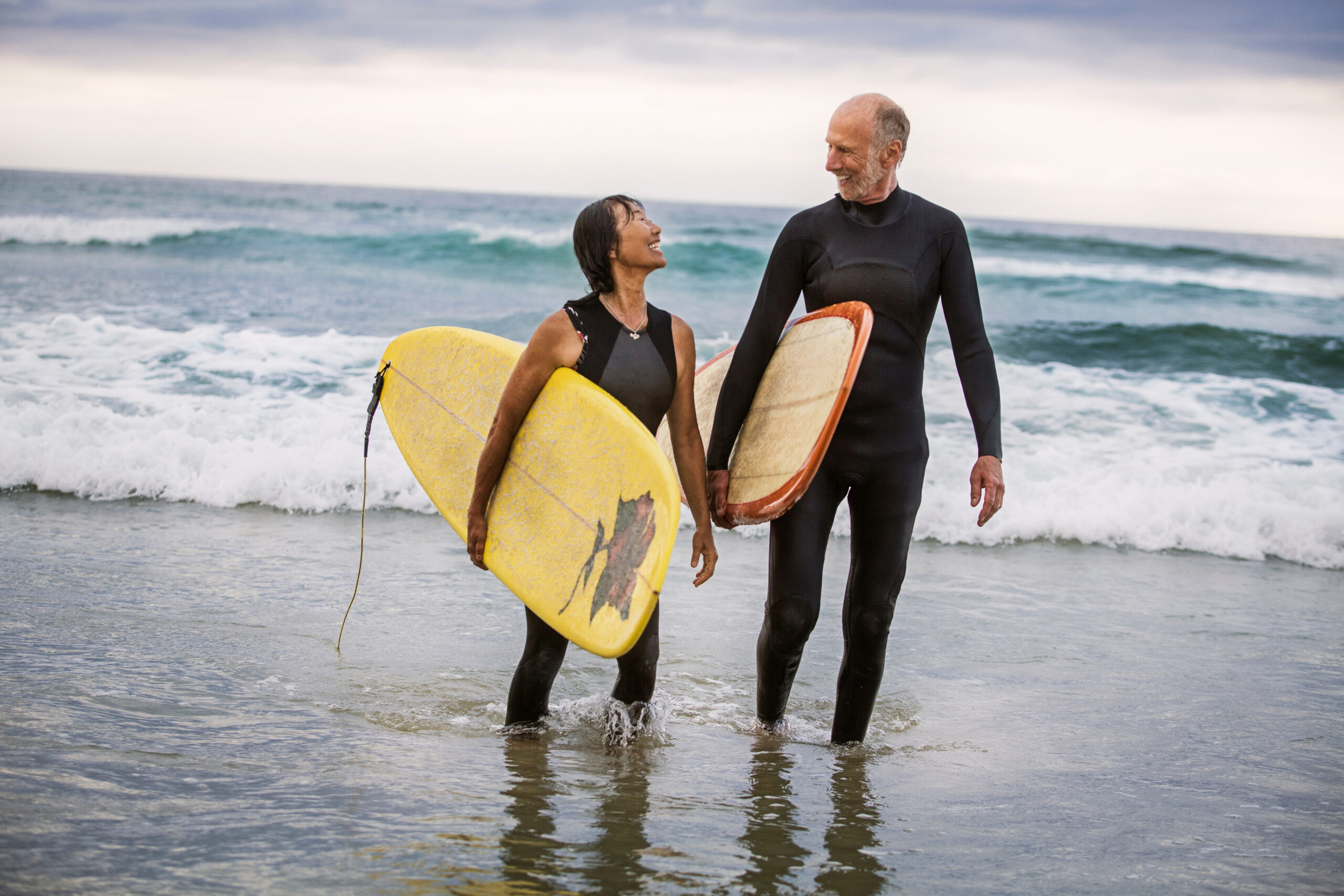 view of senior surfers wearing wetsuits