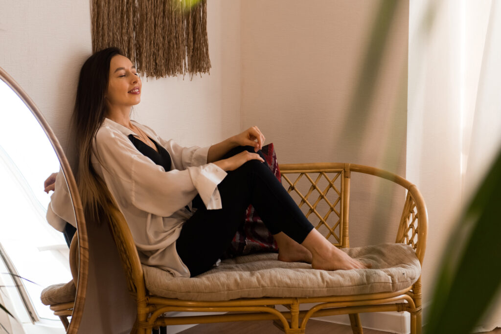 young beautiful woman sitting on bench at home, well being concept